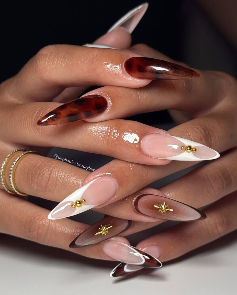 stiletto nails with tortoiseshell art white french tips and gold studs
