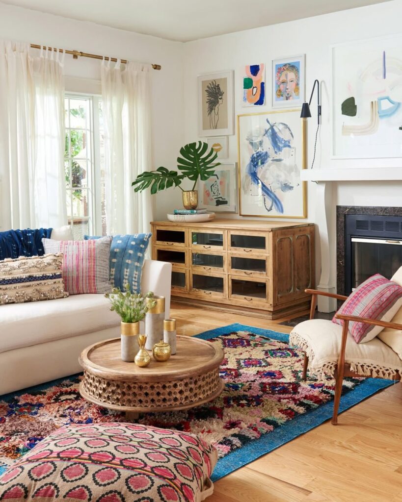 bohemian living room featuring colorful pillows, patterned rugs, and an eclectic gallery wall of art.