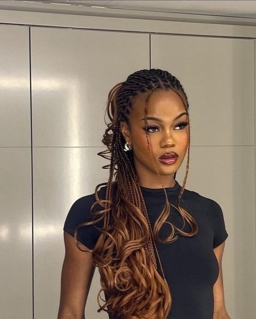 woman with honey brown goddess braids and voluminous loose curls over one shoulder