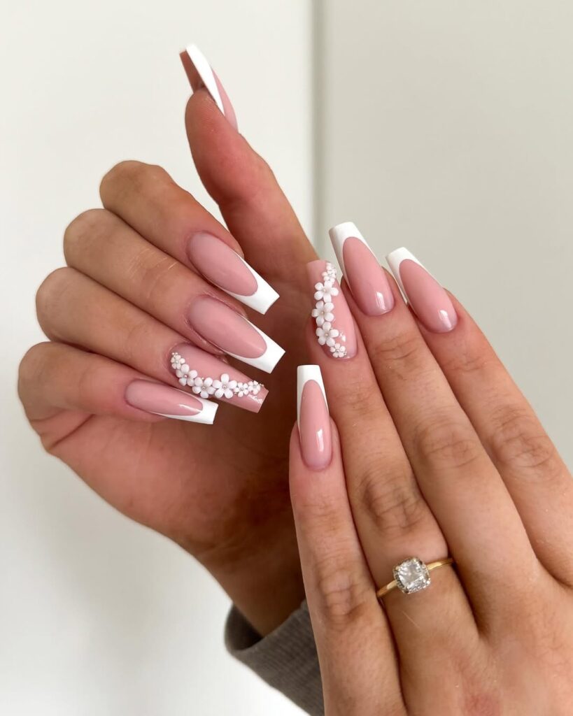 long square french tip nails with white floral 3d nail art and silver gems