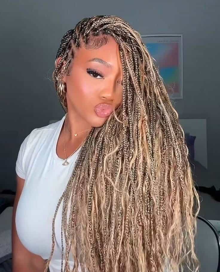 woman with long blonde and brown boho braids with curly ends