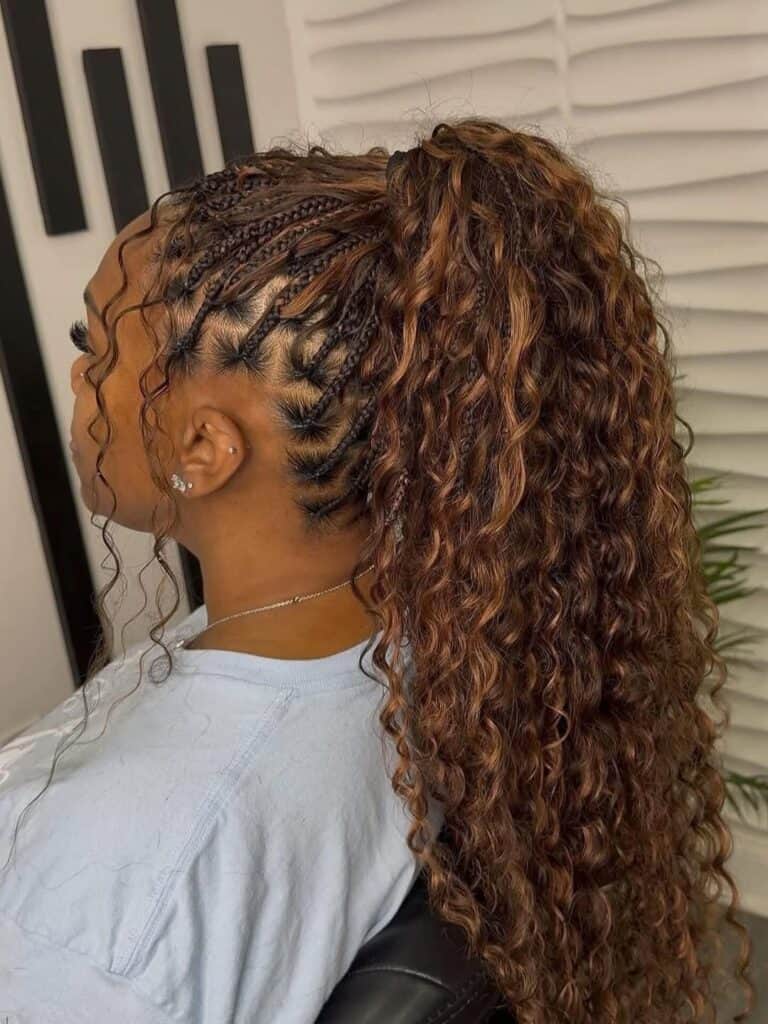 woman with long curly brown hair styled in a high braided ponytail