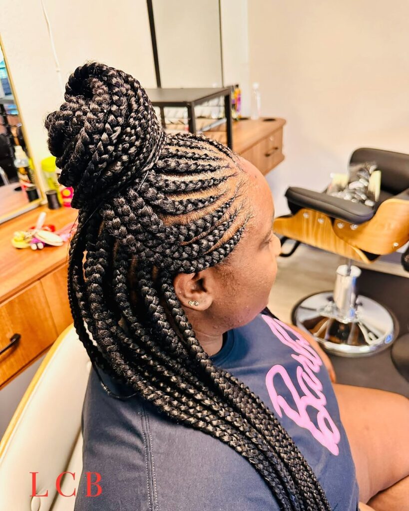side view of a braided updo bun with long braids hanging down her back