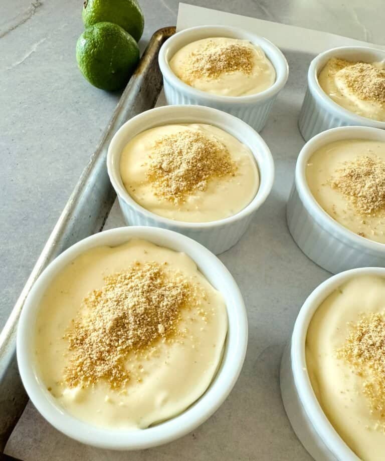 no bake key lime pie cups topped with graham cracker crumbs on a baking sheet