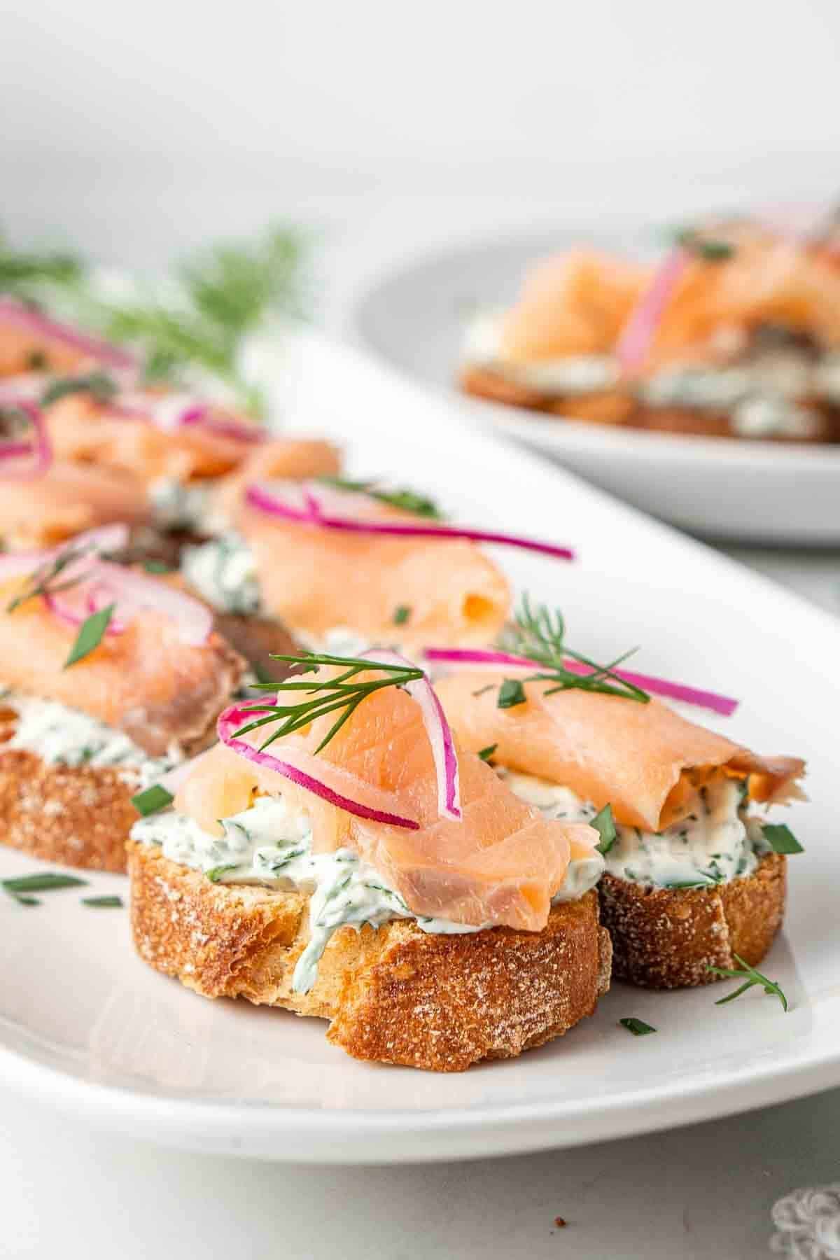 smoked salmon crostini with herb cream cheese, red onion, and fresh dill