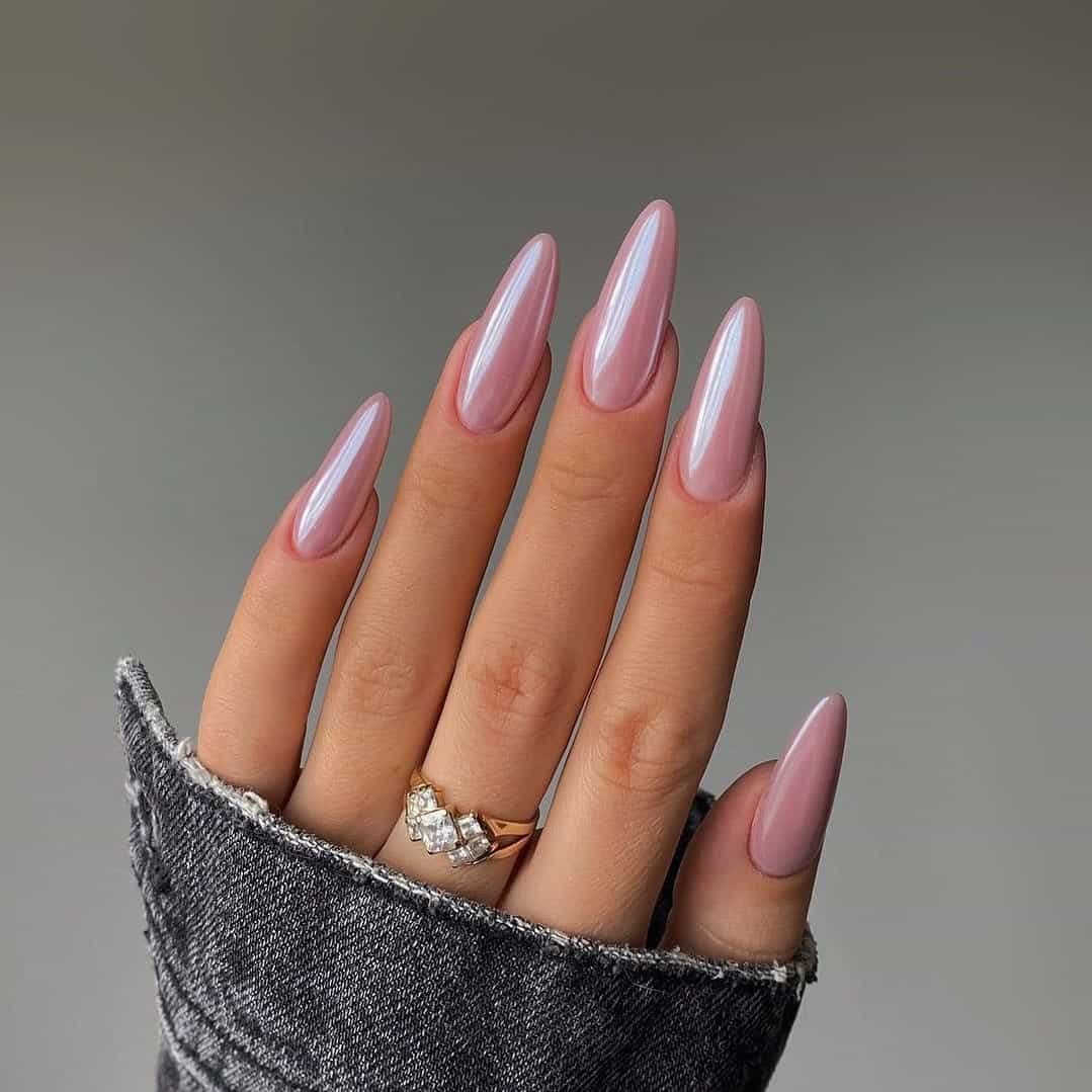 almond shaped light pink iridescent manicure with gold ring
