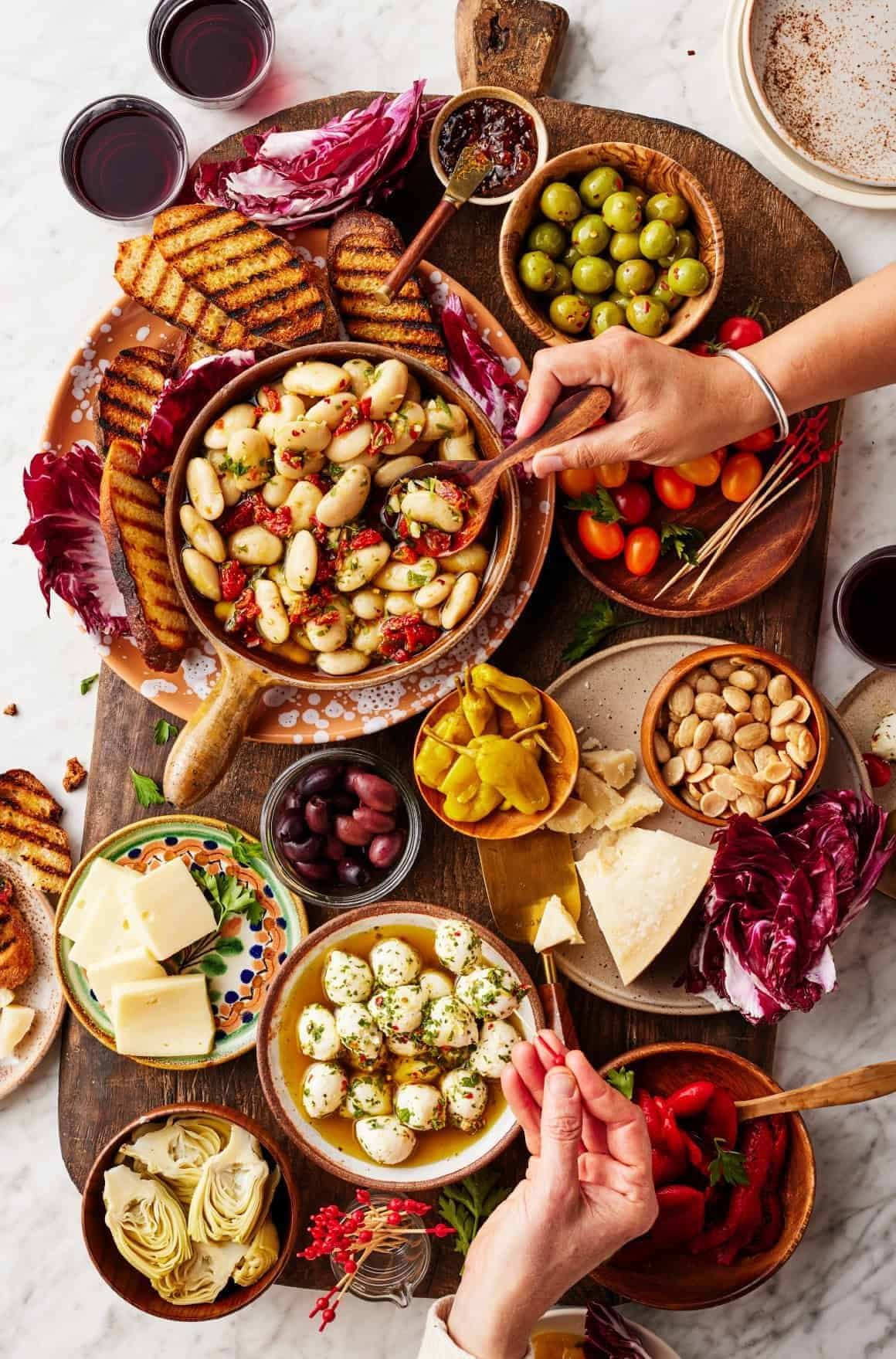 antipasto platter with white beans, olives, cheese, and grilled bread