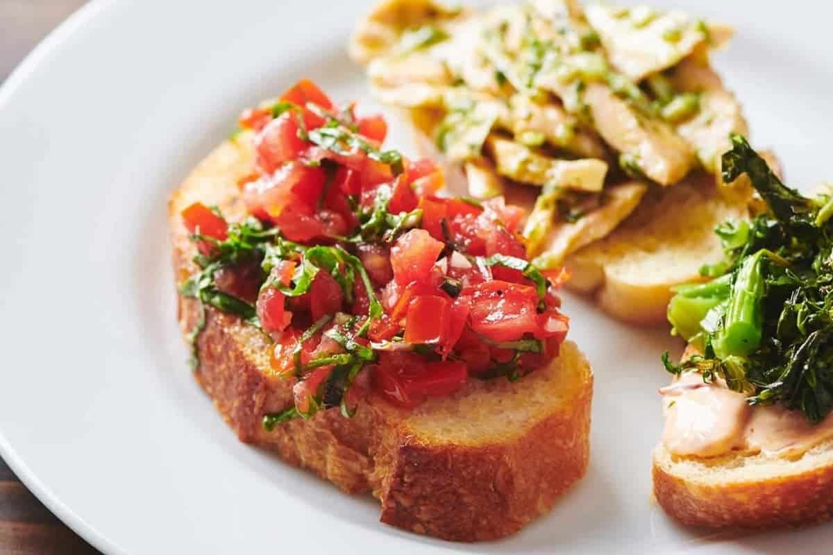 toasted baguette topped with fresh tomato and basil bruschetta