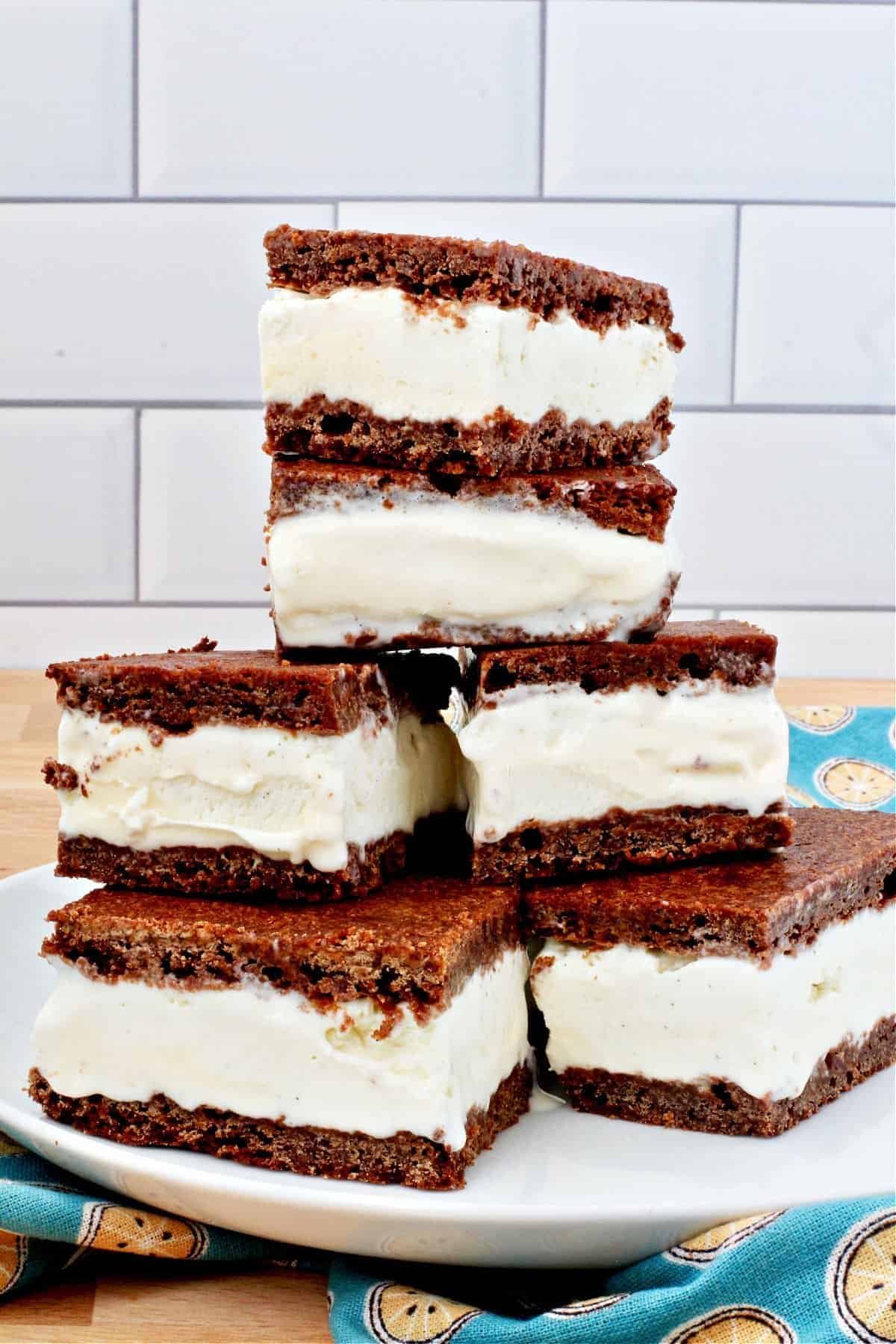 a tall stack of homemade chocolate ice cream sandwiches filled with thick vanilla cream
