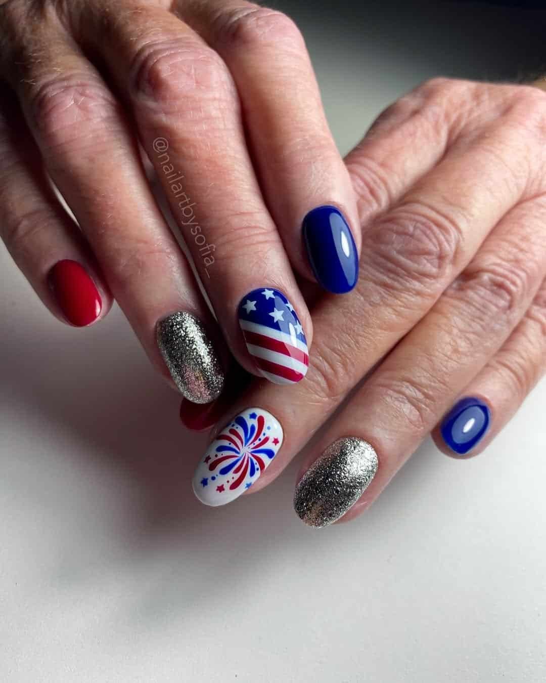 red and blue nails featuring silver glitter and american flag firework art.