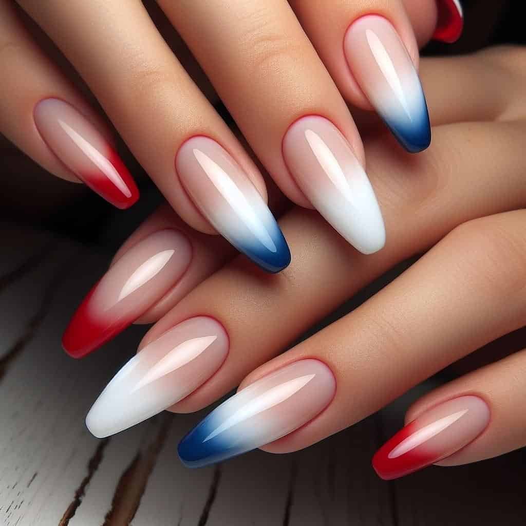 long almond nails with a red, white, and blue ombre gradient effect.