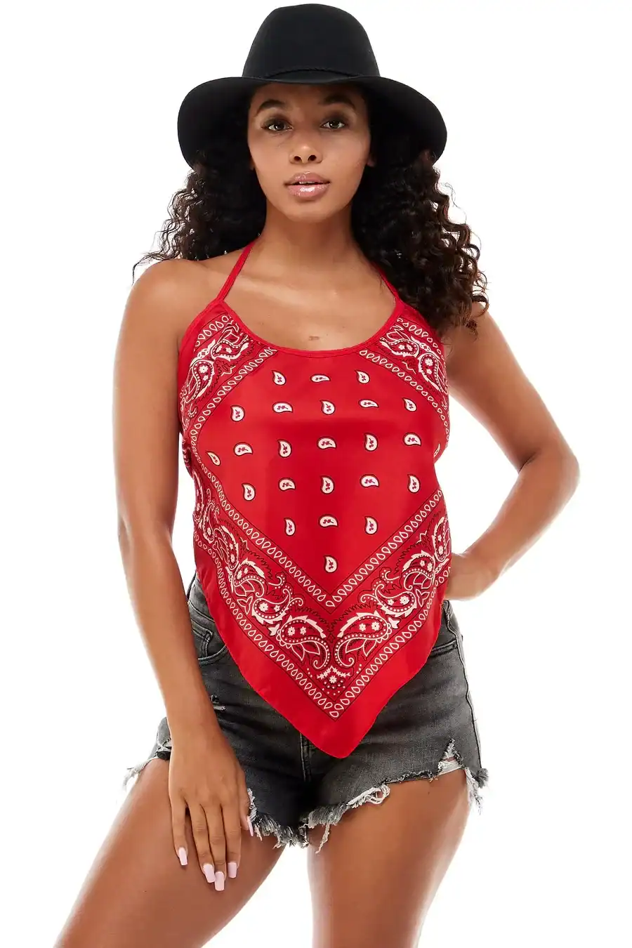 woman wearing red bandana print halter top and denim shorts with black hat.