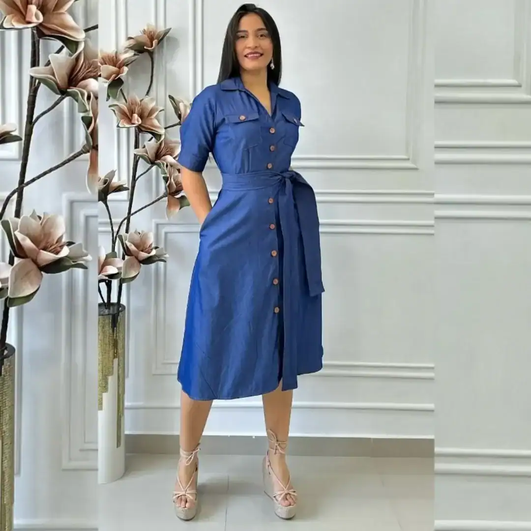 woman wearing a blue denim button down midi dress with a waist tie