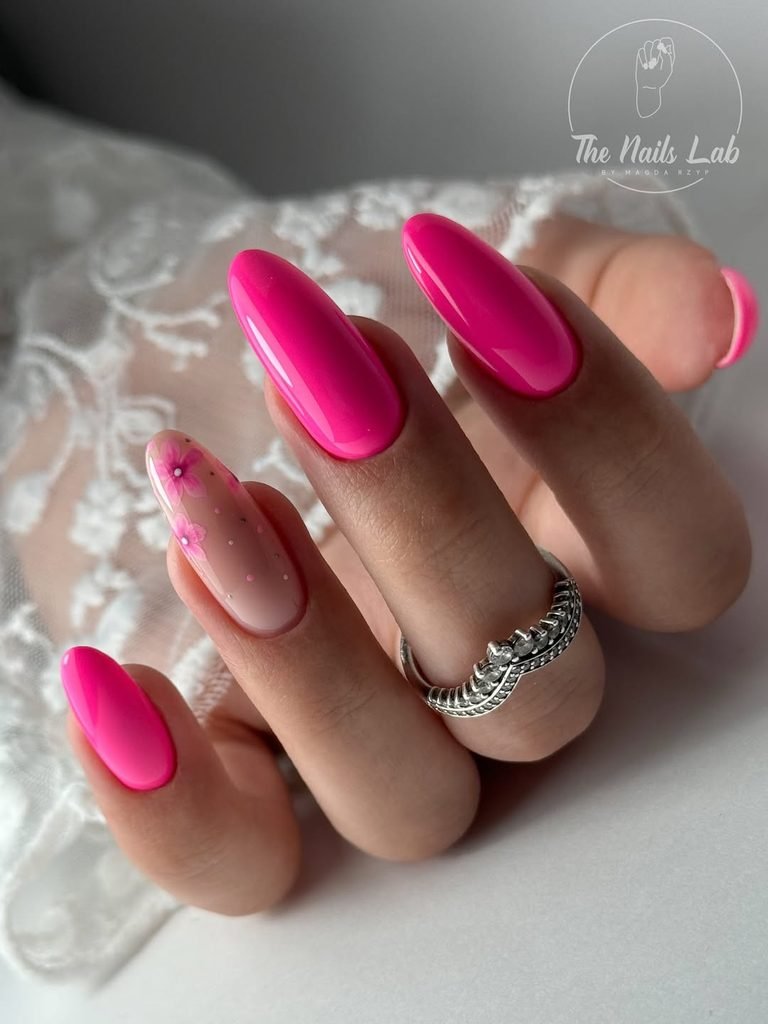 bright magenta oval nails with one accent nail featuring pink flowers