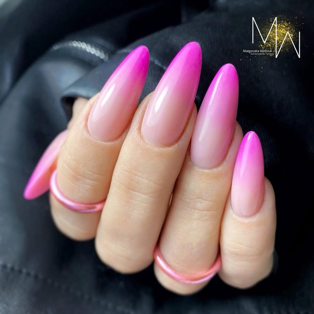 long stiletto nails with a pink and nude ombre gradient design