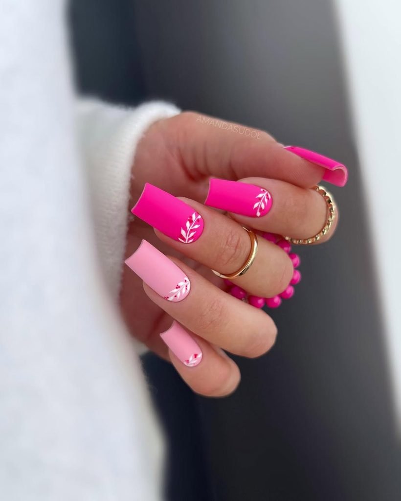 bright pink and light pink square nails with white leaf nail art