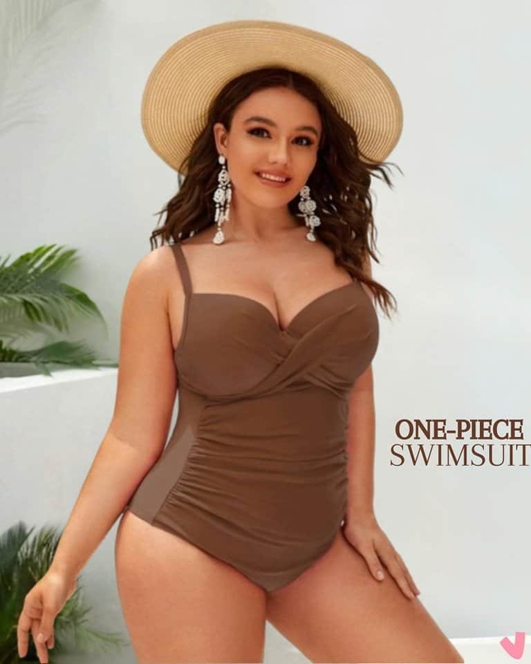 woman wearing a ruched brown one-piece swimsuit and a wide-brimmed straw hat