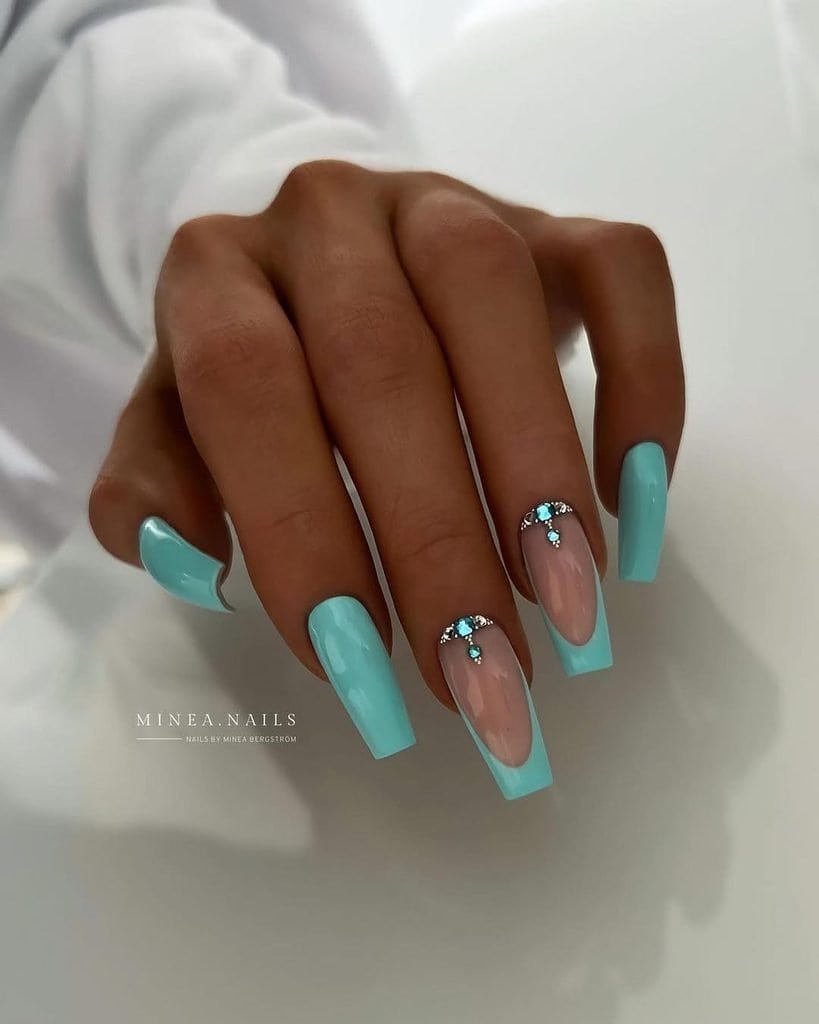 mint blue coffin nails featuring a french tip design and small rhinestone gems
