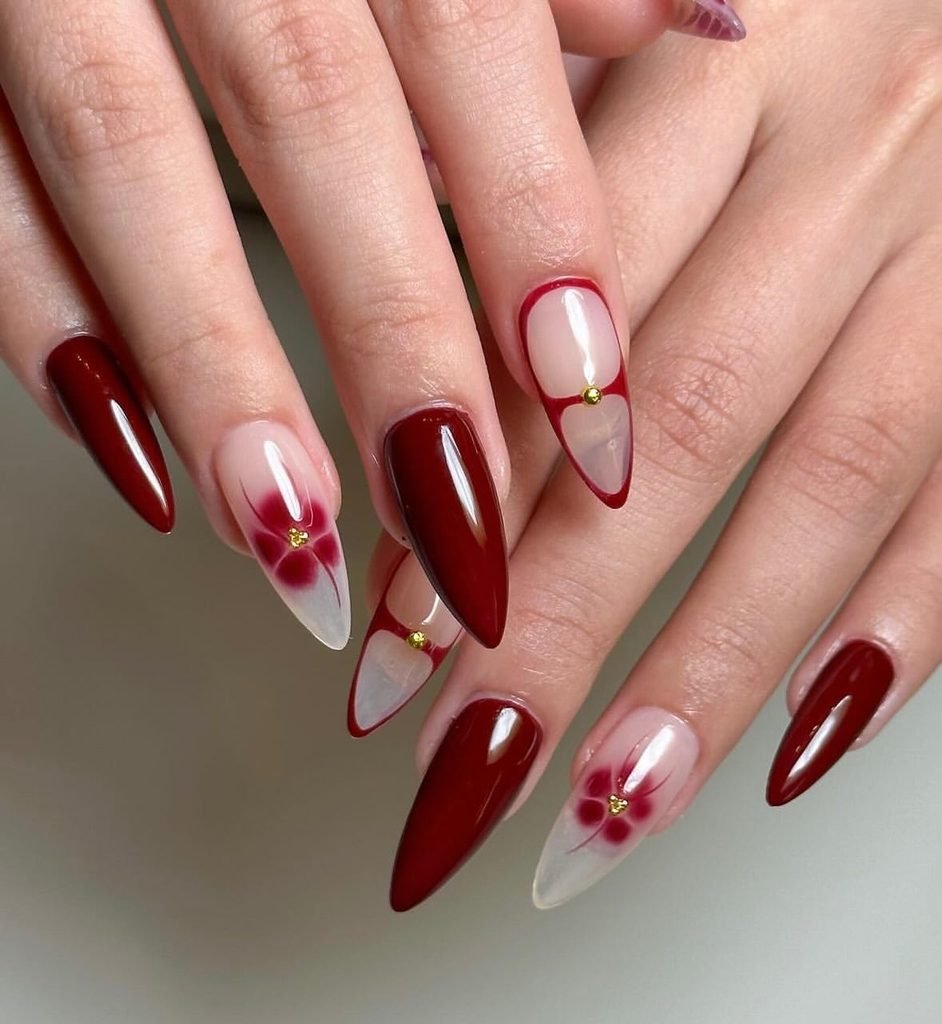long almond nails with deep red polish and blooming gel floral art