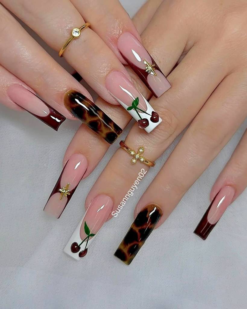 long square french manicure with dark brown tips tortoise shell and cherry art