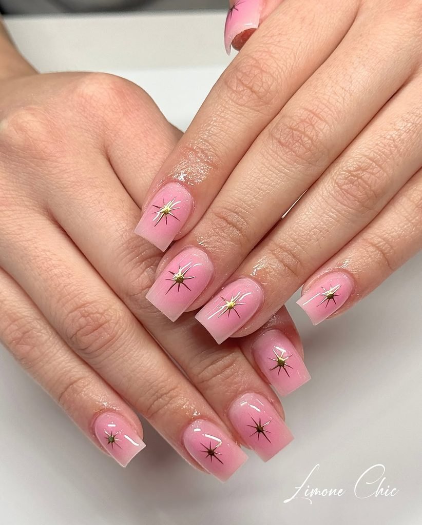 short square pink ombré nails featuring gold starburst designs