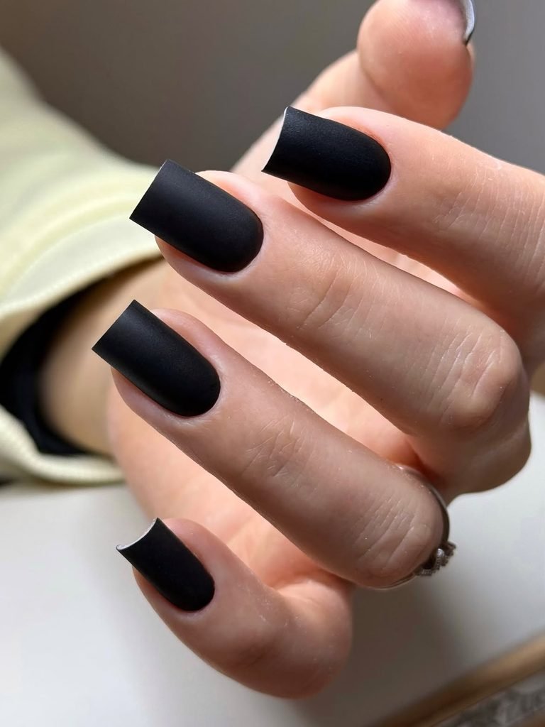 matte black square manicure on long fingers