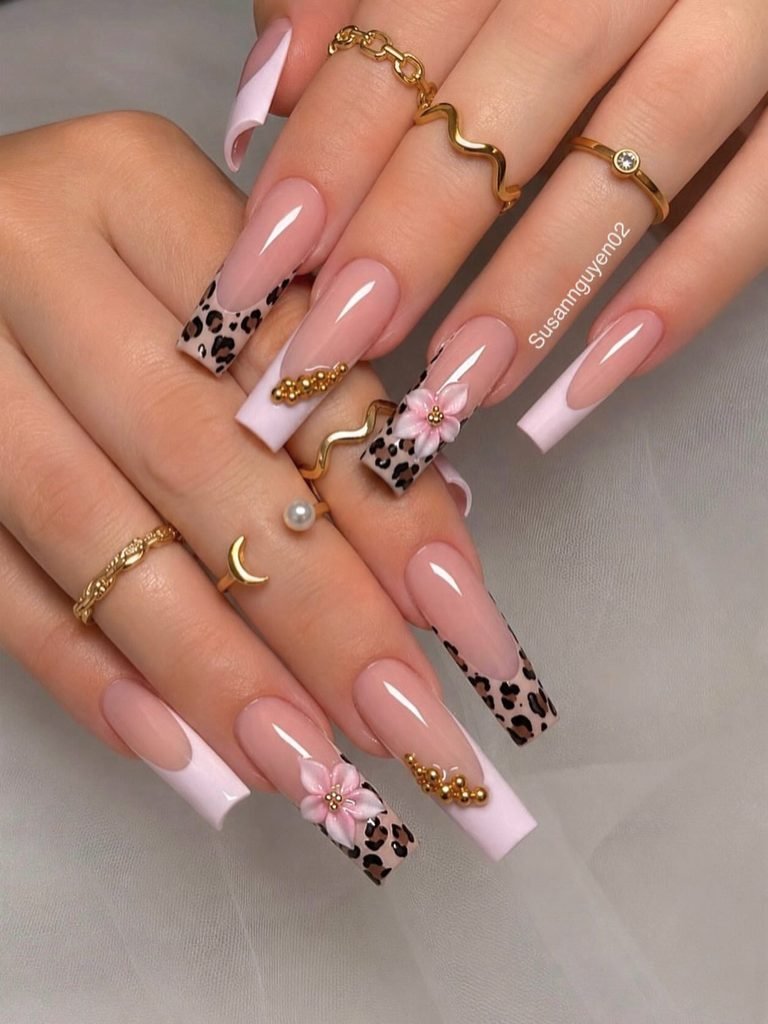 long square french tip manicure with leopard print accents and 3d flowers