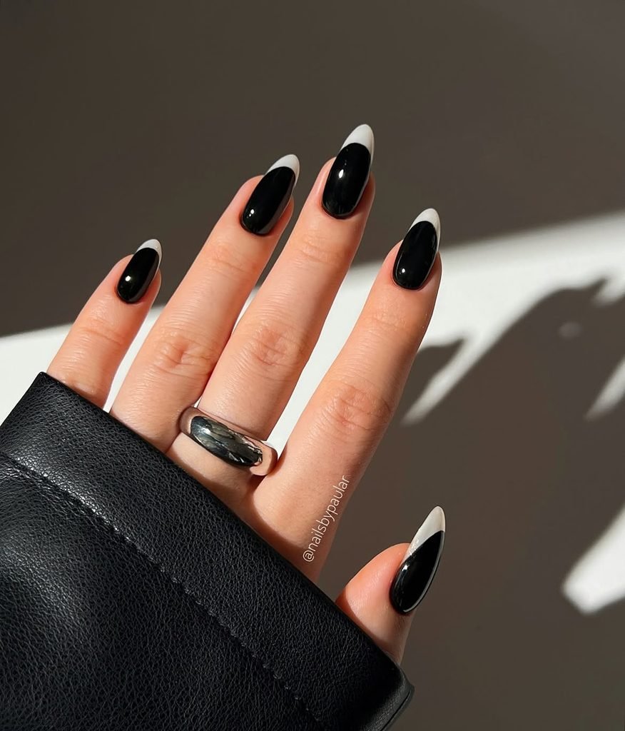 glossy black almond manicured nails with crisp white french tips