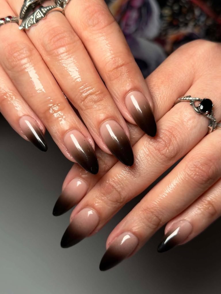 long almond manicured nails with black and nude ombre gradient polish