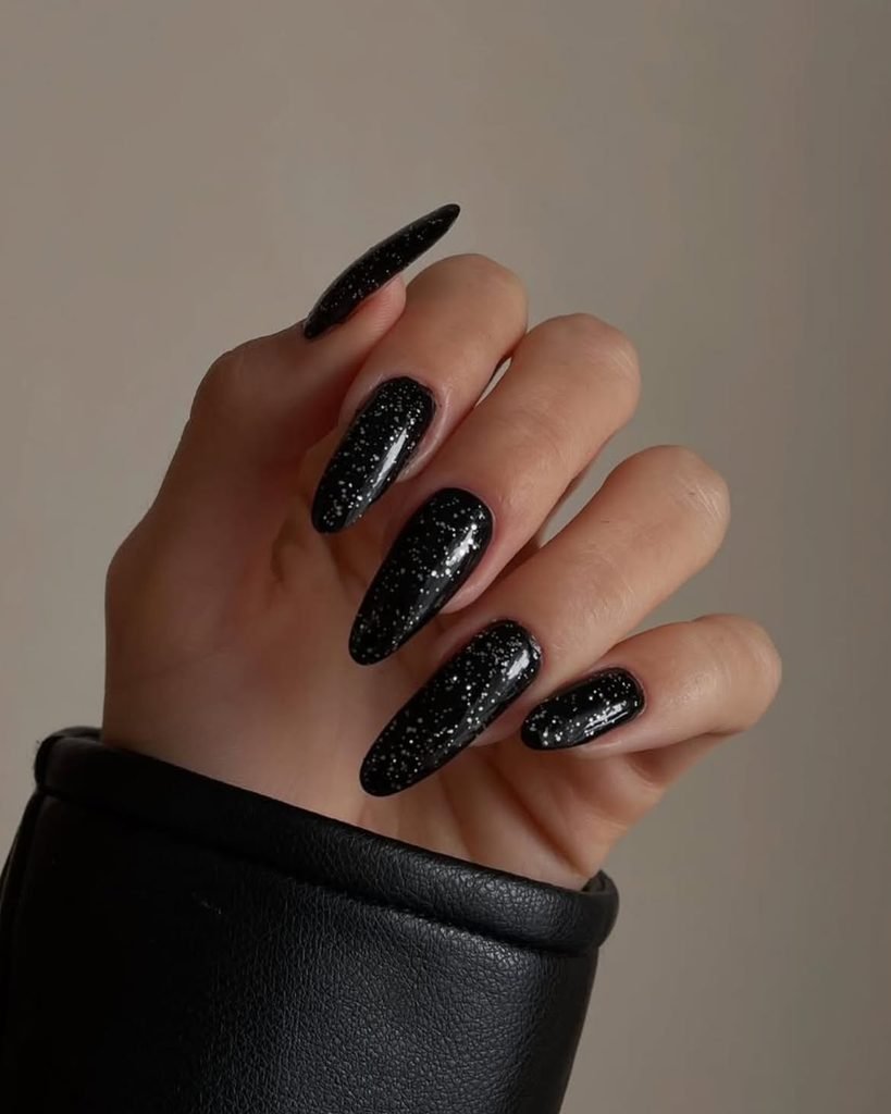 long black almond manicured nails with fine silver glitter polish