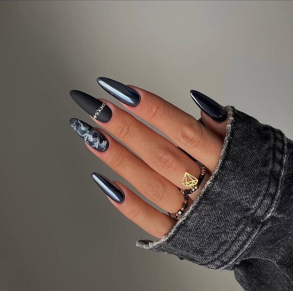 long almond nails featuring matte black chrome mirror and marble accent designs