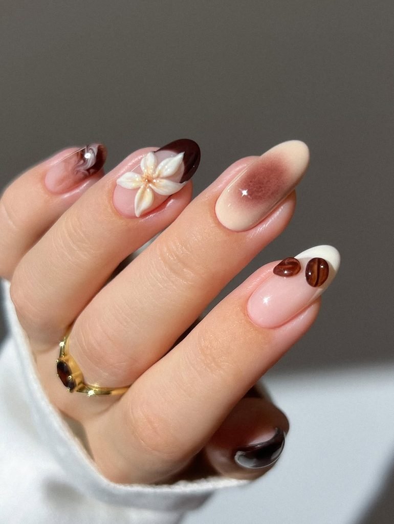 coffee themed nail art featuring 3d flower and coffee bean accents