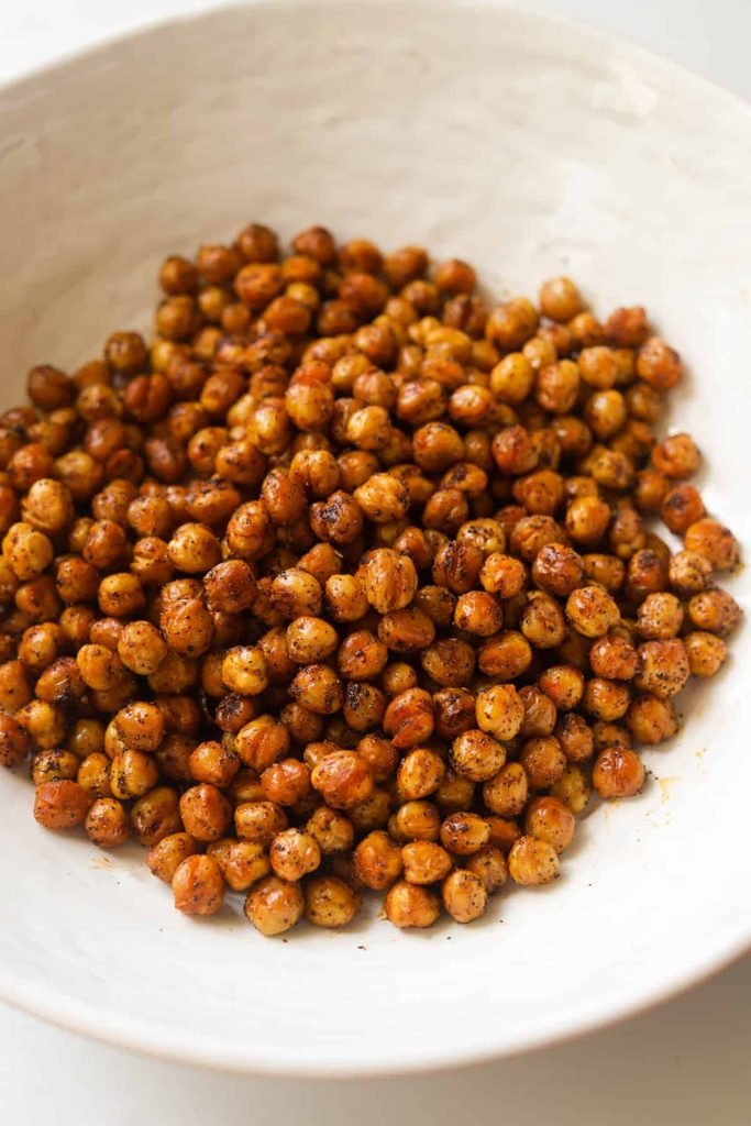 seasoned spicy roasted chickpeas served in a white ceramic bowl