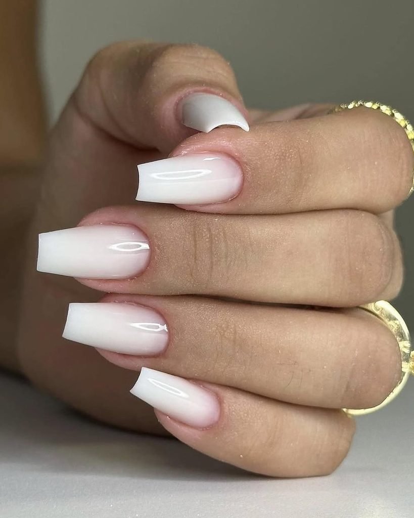 glossy coffin shaped nails with a clean smooth white ombre fade finish