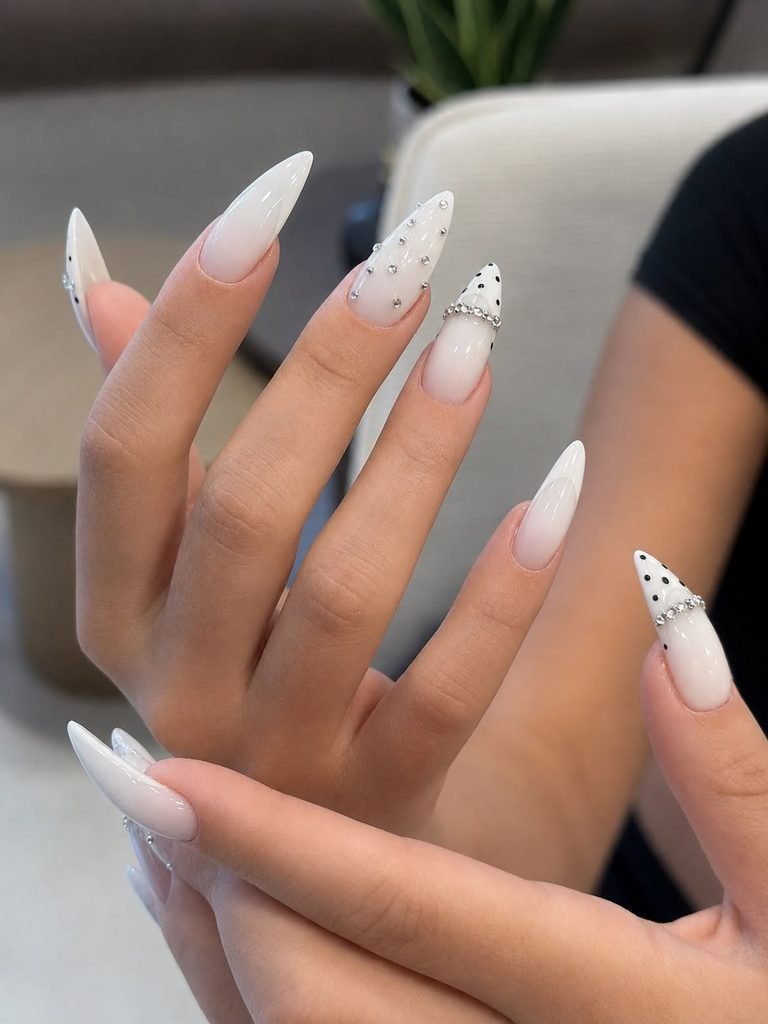 long stiletto milky ombre nails decorated with subtle rhinestones and black polka dots
