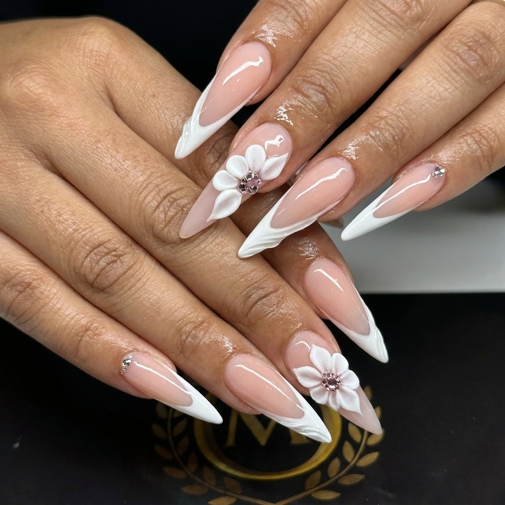 long stiletto french nails featuring white 3d flower accents and tiny rhinestones