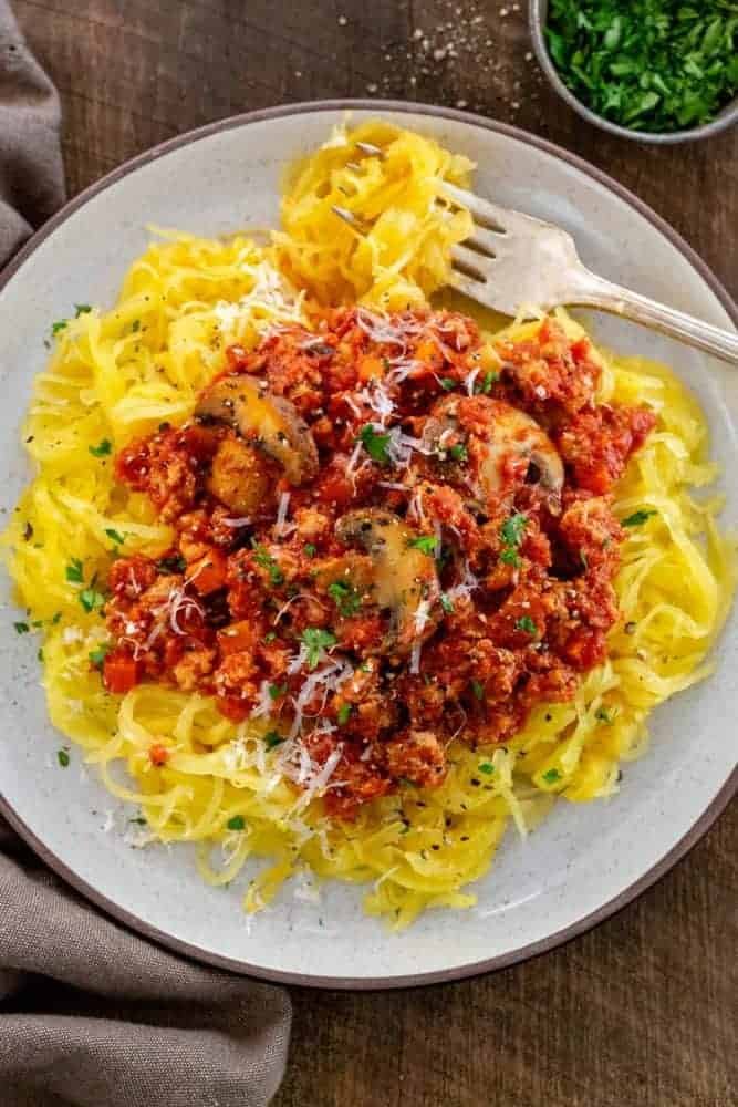 turkey bolognese sauce served over roasted spaghetti squash noodles on a plate