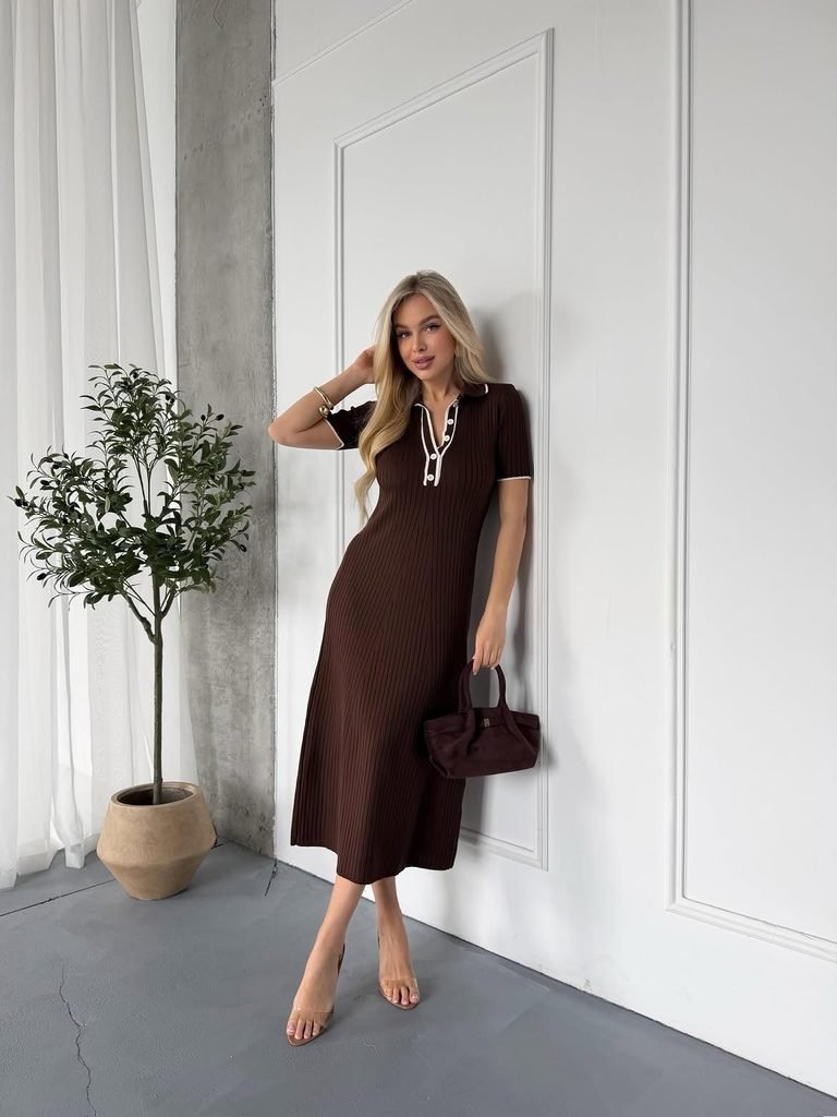 woman wearing a brown ribbed polo midi dress holding a matching handbag