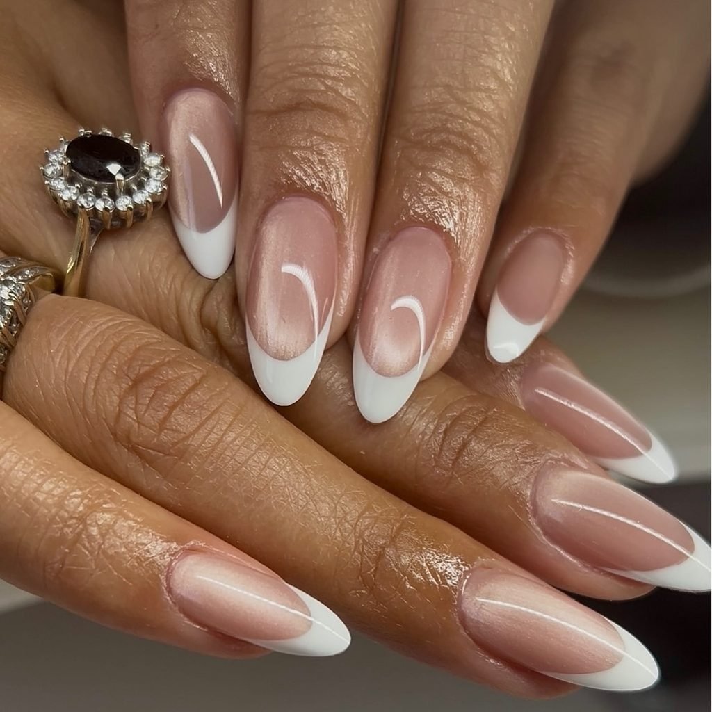 classic white tip french manicure on shiny almond shaped nails