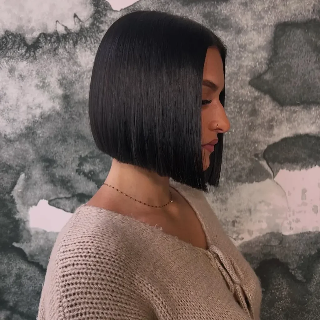 sleek blunt black bob haircut with straight ends and side parting