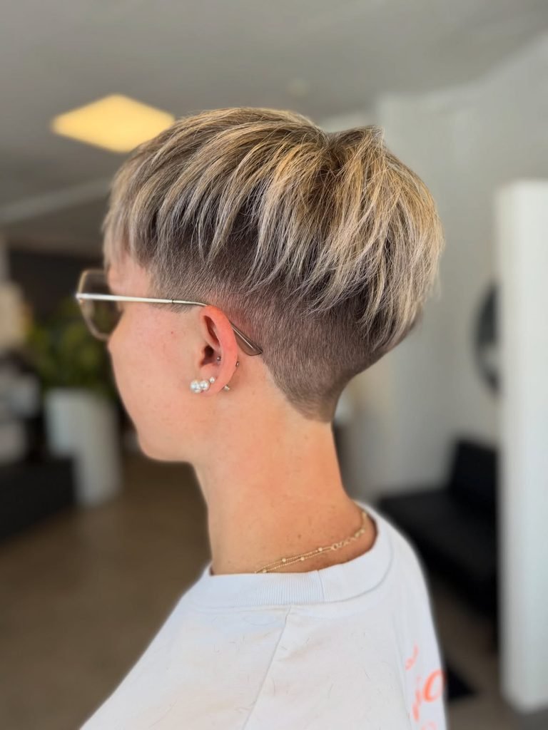 short textured blonde pixie haircut with tapered sides and layered top