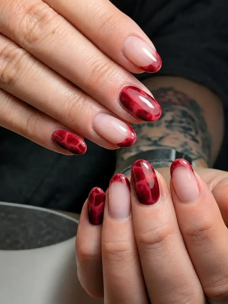 deep red tortoise shell patterned nails mixed with french tip designs   