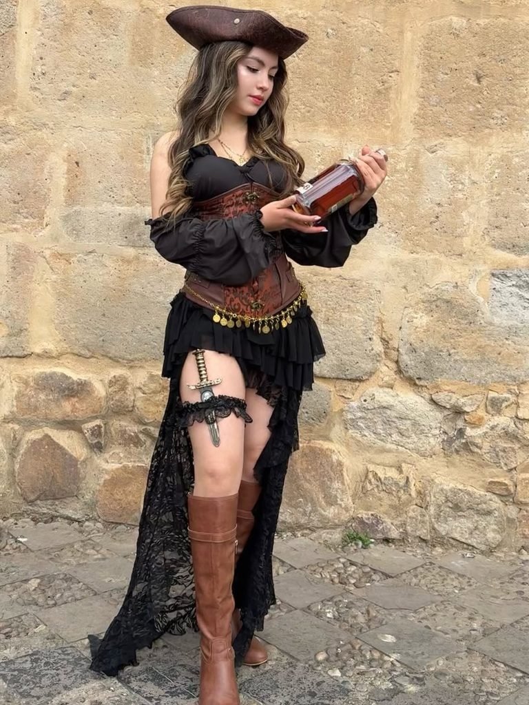 woman wearing a pirate costume with a tricorn hat corset and leather boots   