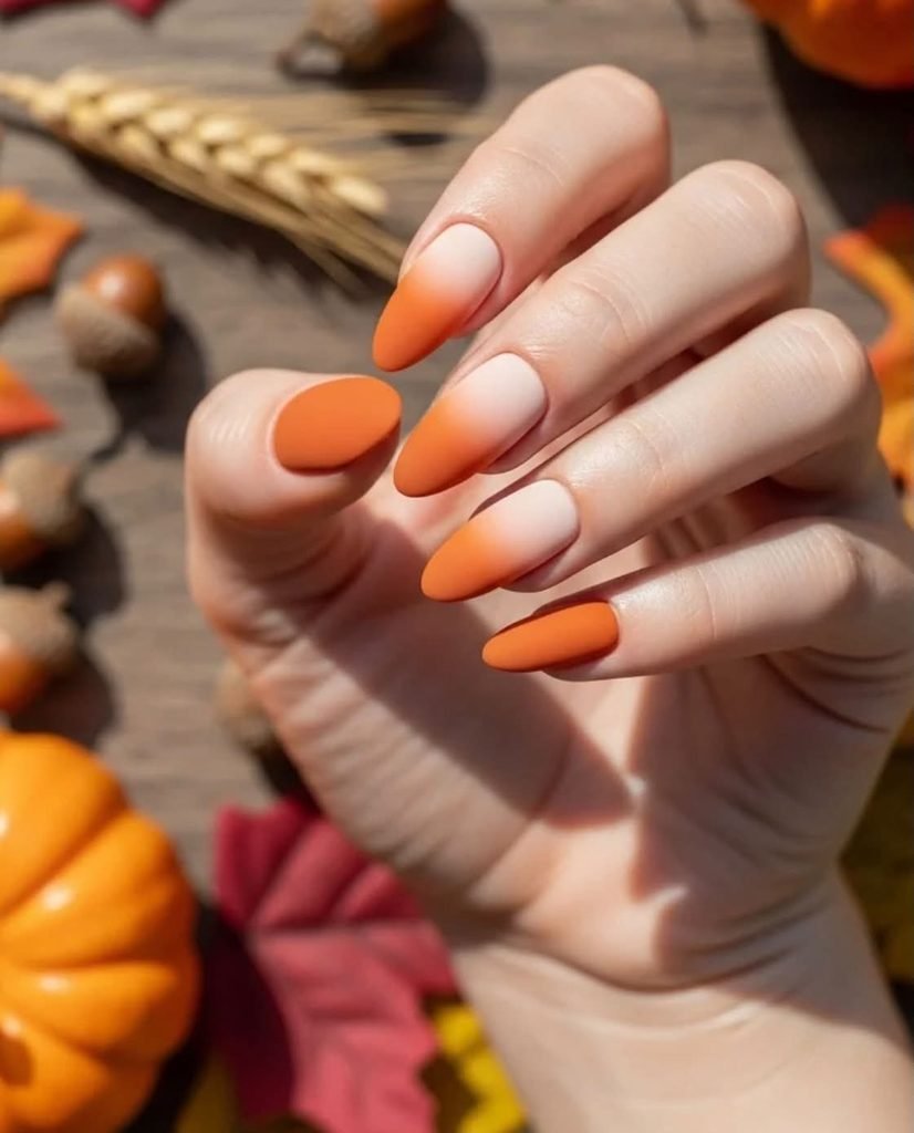 matte orange and white gradient ombre autumn nails on almond shaped tips