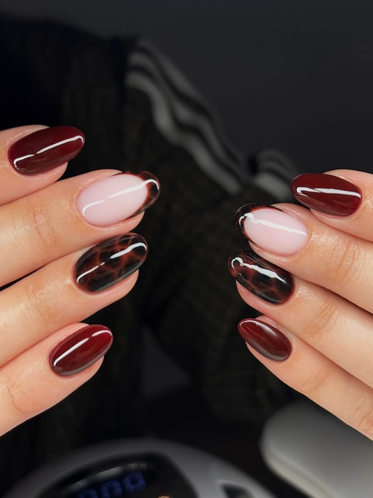 dark red and tortoiseshell pattern manicure on short oval nails