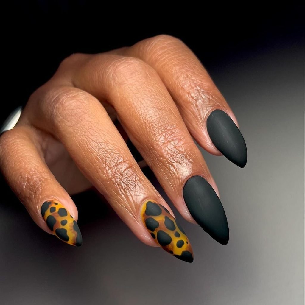 matte black and leopard tortoiseshell pattern print manicure on almond nails