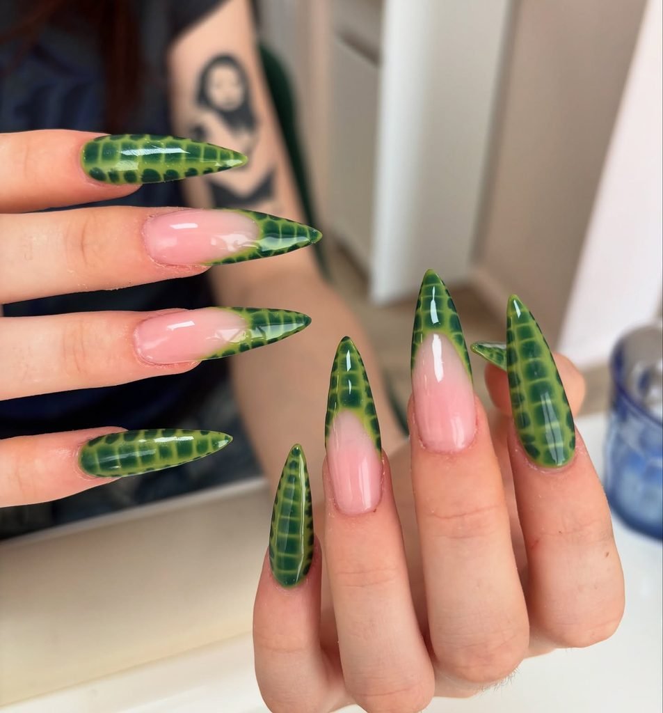 long stiletto nails featuring green crocodile skin pattern and french tips