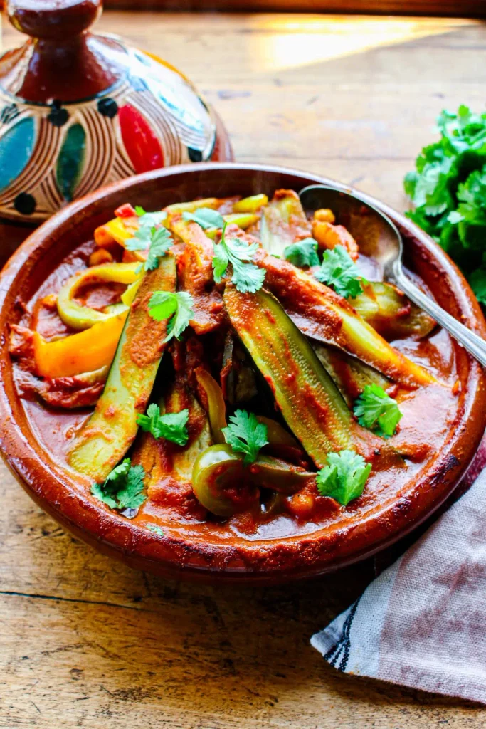 vegetable and chickpea tagine with sliced zucchini in a traditional clay dish   