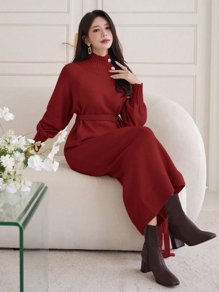 woman wearing a red turtleneck sweater dress and dark brown ankle boots