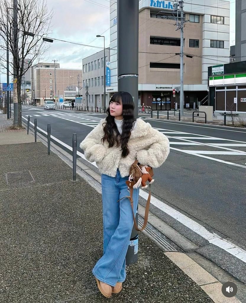 woman wearing a fleece jacket, wide leg jeans, and platform shoes